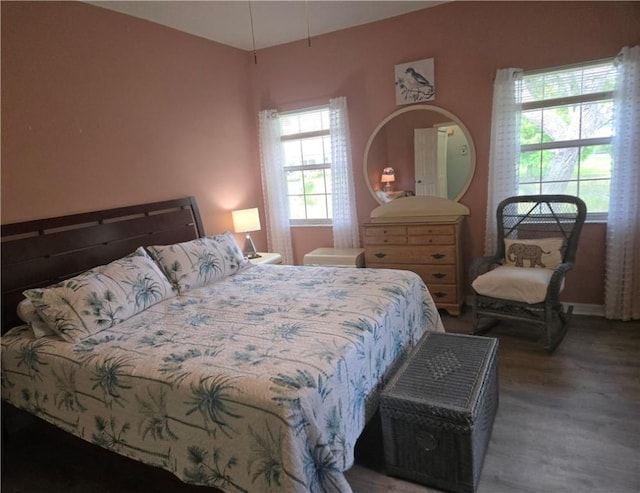 bedroom with wood finished floors and baseboards