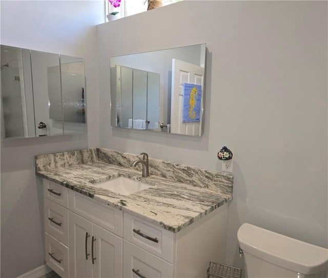 bathroom featuring toilet and vanity