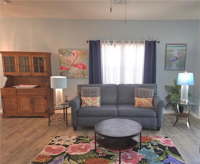living room with baseboards and wood finished floors
