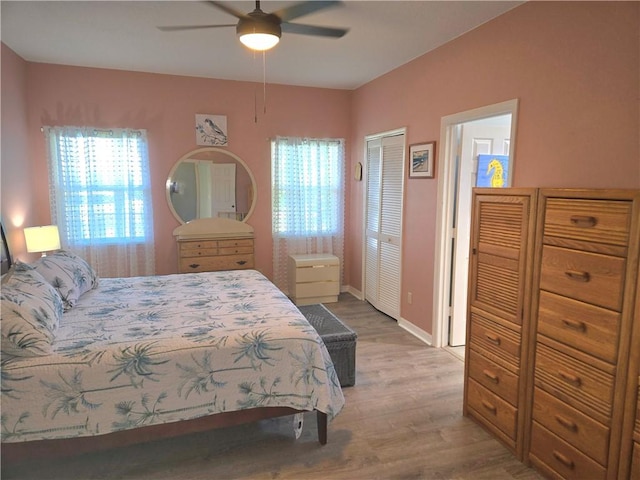 bedroom featuring baseboards, ceiling fan, and wood finished floors