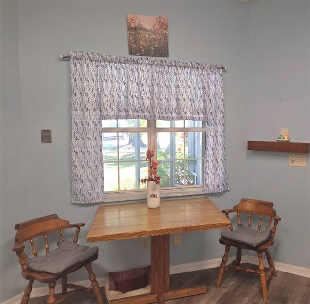 dining space with wood finished floors and baseboards