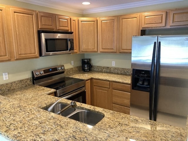 1845 Robalo Dr Unit 201D, Vero Beach, FL 32960 - kitchen with crown molding, appliances with stainless steel finishes, light stone counters, and a sink