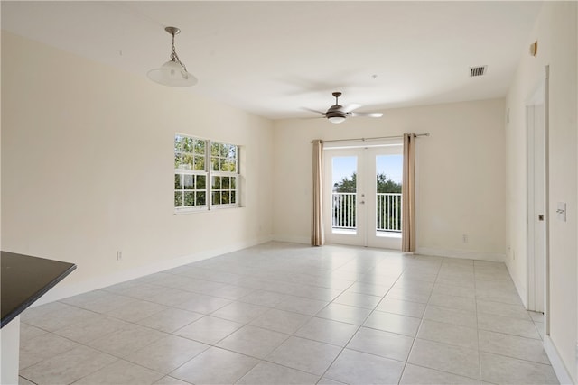 spare room with ceiling fan, french doors, light tile patterned flooring, and plenty of natural light