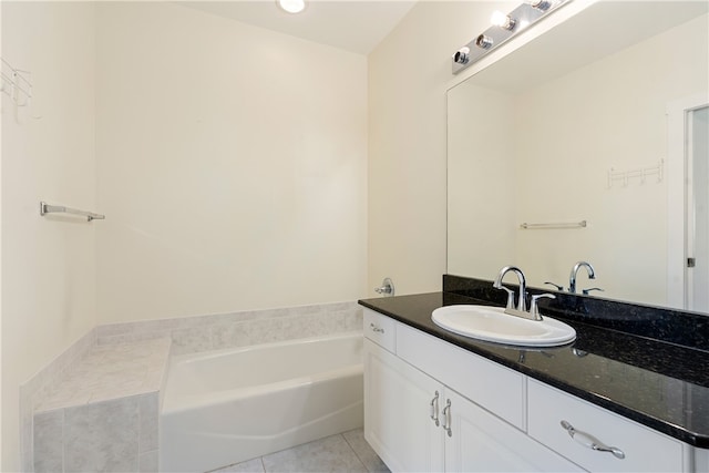 bathroom with vanity, tile patterned floors, and a bath