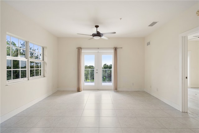 spare room featuring french doors, ceiling fan, and light tile patterned floors