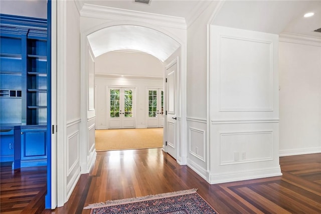 121 Palm Island Ln, Vero Beach, FL 32963 - hall with a decorative wall, arched walkways, dark wood-style floors, and french doors