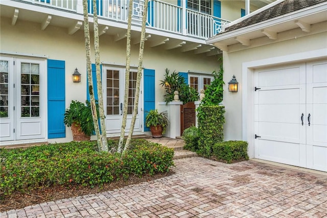 121 Palm Island Ln, Vero Beach, FL 32963 - property entrance with a balcony, french doors, and stucco siding