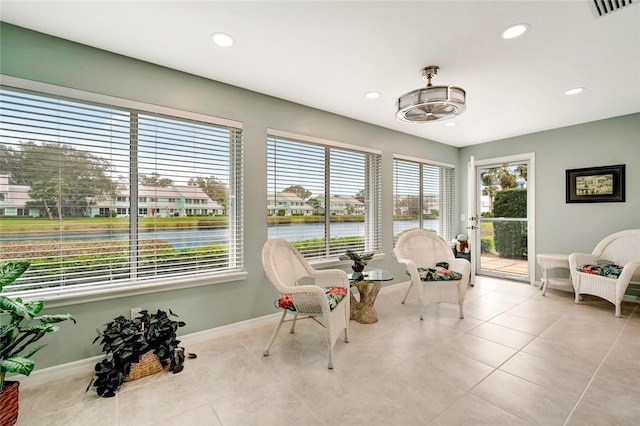 sunroom with a water view and plenty of natural light