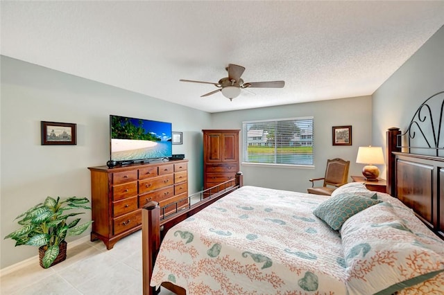 tiled bedroom featuring a textured ceiling and ceiling fan