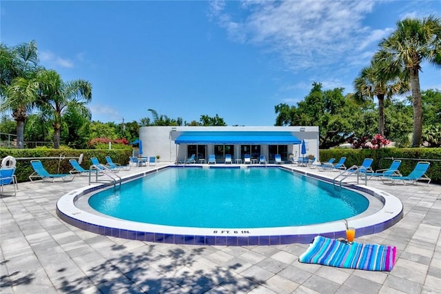 view of swimming pool with a patio