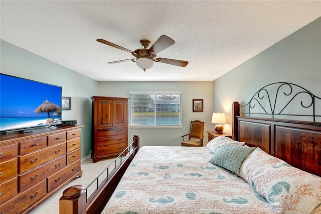 tiled bedroom featuring a textured ceiling and ceiling fan