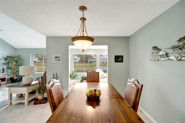 dining space featuring a textured ceiling