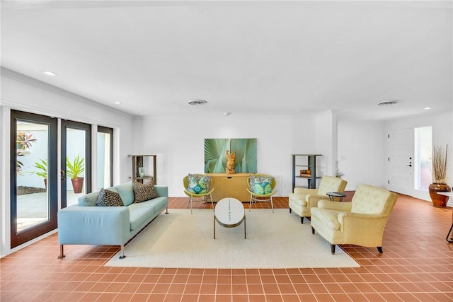 tiled living room featuring crown molding and french doors