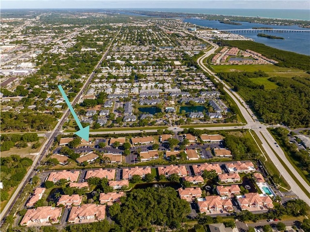 drone / aerial view with a water view and a residential view