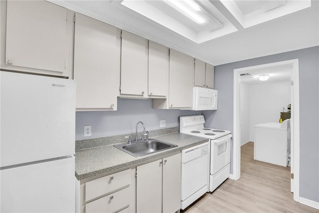kitchen featuring a sink, light countertops, white cabinets, light wood-style floors, and white appliances