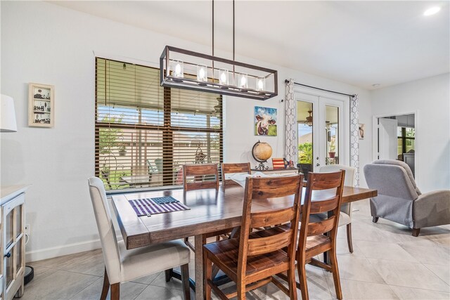 tiled dining space featuring french doors and plenty of natural light