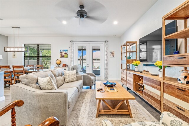 living room with french doors and ceiling fan with notable chandelier