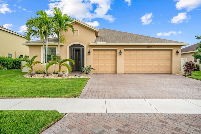 view of front of house with a garage and a front yard