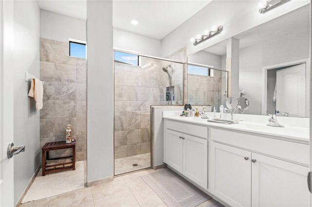 bathroom featuring tile patterned flooring, a shower with door, and plenty of natural light