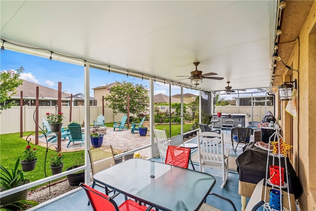 sunroom featuring ceiling fan