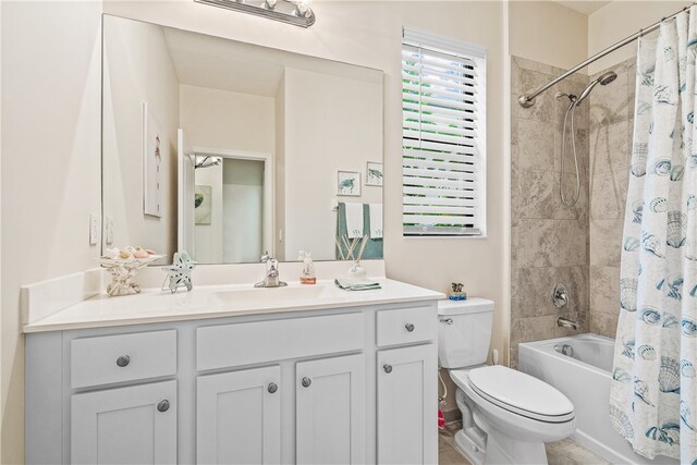 full bathroom featuring shower / bath combo, vanity, and toilet