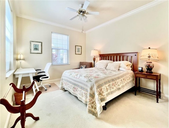 carpeted bedroom with ornamental molding and ceiling fan