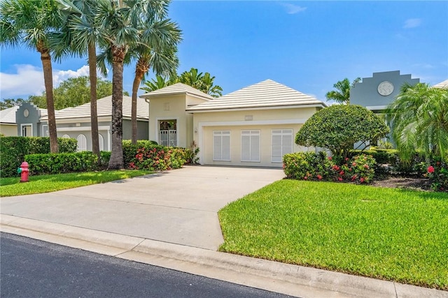 1135 Saint Georges Ln, Vero Beach, FL 32967 - view of front of property featuring driveway, a front lawn, and stucco siding