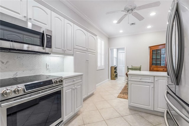 1135 Saint Georges Ln, Vero Beach, FL 32967 - kitchen with appliances with stainless steel finishes, crown molding, light countertops, white cabinets, and ceiling fan