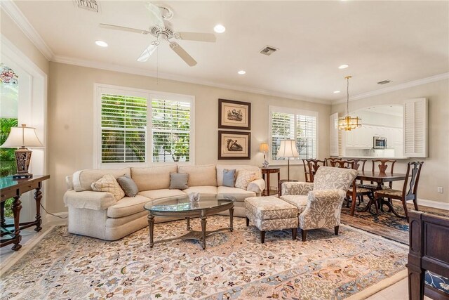 1135 Saint Georges Ln, Vero Beach, FL 32967 - living room with a ceiling fan, plenty of natural light, crown molding, recessed lighting, and a chandelier