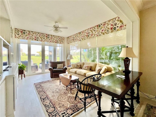 sunroom / solarium with ceiling fan and french doors