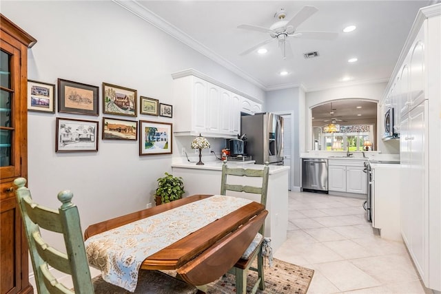 1135 Saint Georges Ln, Vero Beach, FL 32967 - dining space featuring a ceiling fan, recessed lighting, ornamental molding, light tile patterned floors, and arched walkways