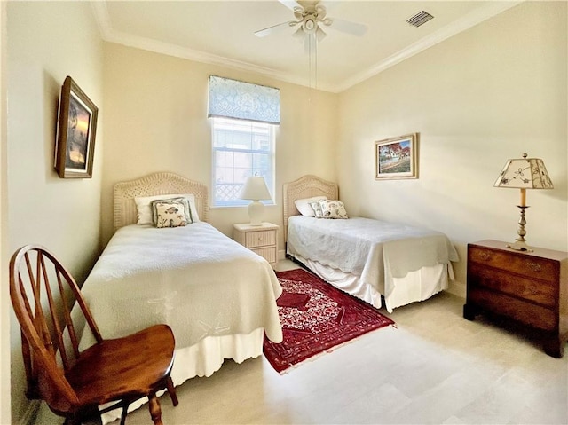 bedroom with ornamental molding, light colored carpet, and ceiling fan