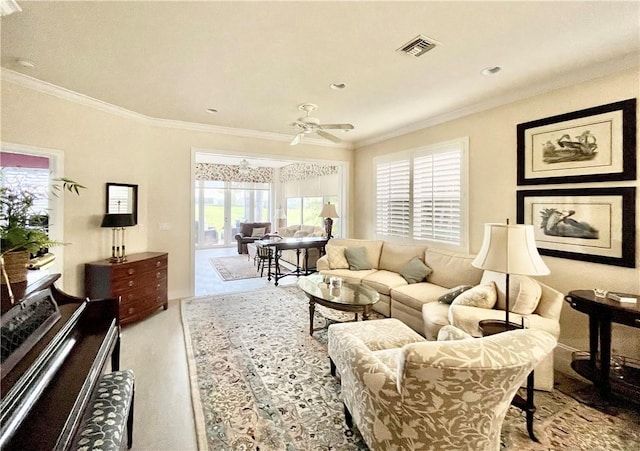 living room with ornamental molding and ceiling fan