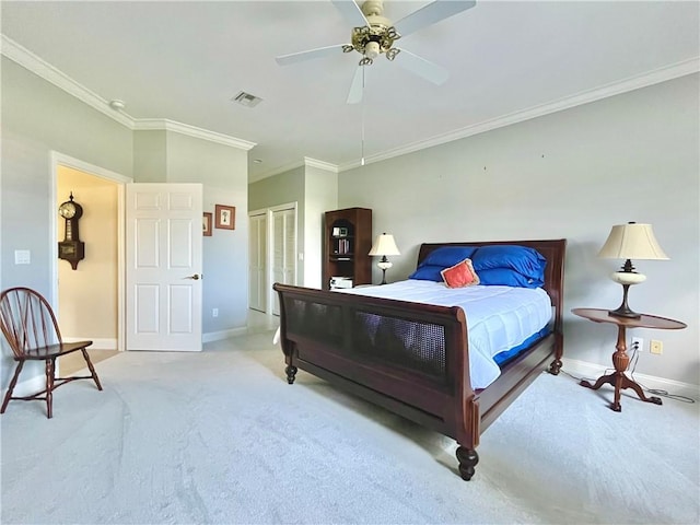 carpeted bedroom featuring ceiling fan, ornamental molding, and a closet