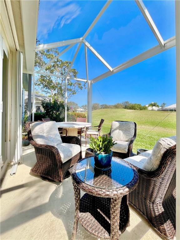 view of patio / terrace featuring glass enclosure