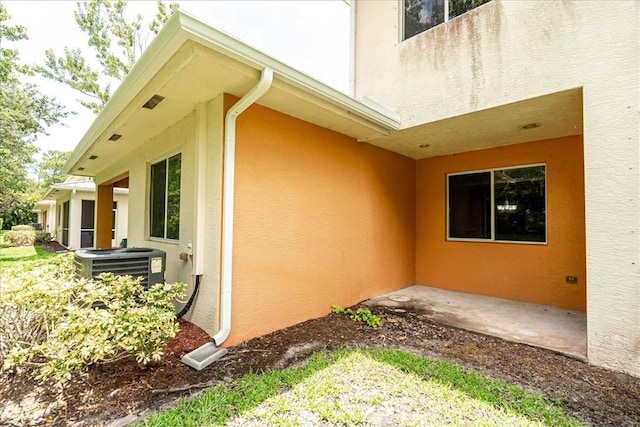 2597 Stockbridge Sq SW Unit 2597, Vero Beach, FL 32962 - view of home's exterior featuring stucco siding and cooling unit
