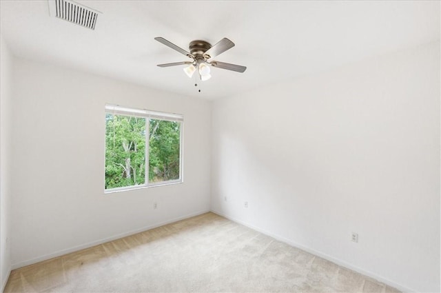 2597 Stockbridge Sq SW Unit 2597, Vero Beach, FL 32962 - empty room with light colored carpet, baseboards, and ceiling fan