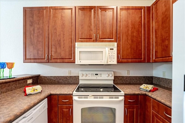 2597 Stockbridge Sq SW Unit 2597, Vero Beach, FL 32962 - kitchen featuring white appliances and dark countertops
