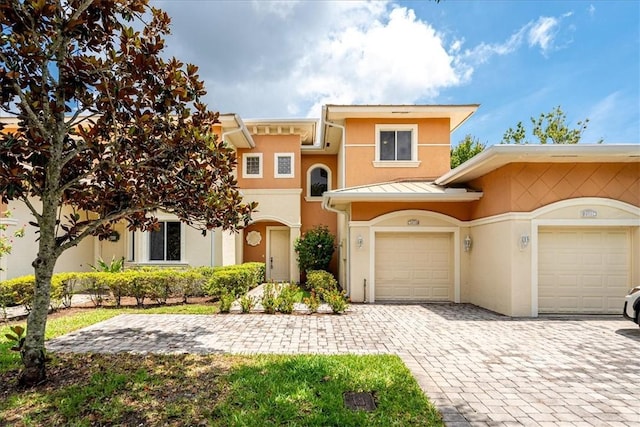 2597 Stockbridge Sq SW Unit 2597, Vero Beach, FL 32962 - view of front of property with stucco siding, decorative driveway, a standing seam roof, metal roof, and an attached garage