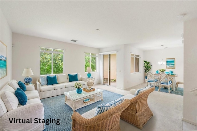 2597 Stockbridge Sq SW Unit 2597, Vero Beach, FL 32962 - living area featuring carpet, a chandelier, and baseboards