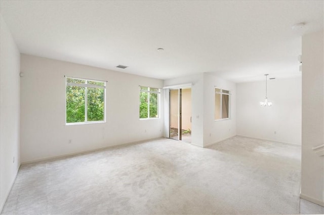 2597 Stockbridge Sq SW Unit 2597, Vero Beach, FL 32962 - empty room with baseboards, a chandelier, and light carpet