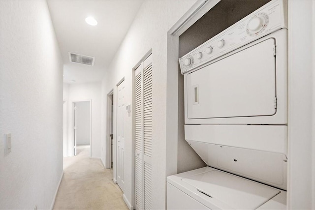 2597 Stockbridge Sq SW Unit 2597, Vero Beach, FL 32962 - washroom featuring estacked washer and dryer, light carpet, baseboards, and recessed lighting
