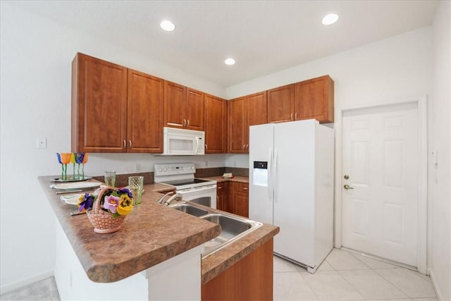 2597 Stockbridge Sq SW Unit 2597, Vero Beach, FL 32962 - kitchen with white appliances, a peninsula, brown cabinetry, recessed lighting, and a sink