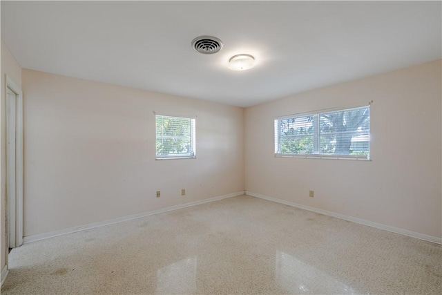 1936 5th Ave, Vero Beach, FL 32960 - spare room with speckled floor and baseboards