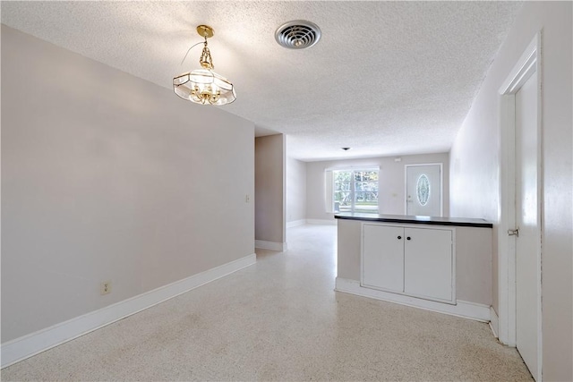 1936 5th Ave, Vero Beach, FL 32960 - spare room featuring a textured ceiling and baseboards