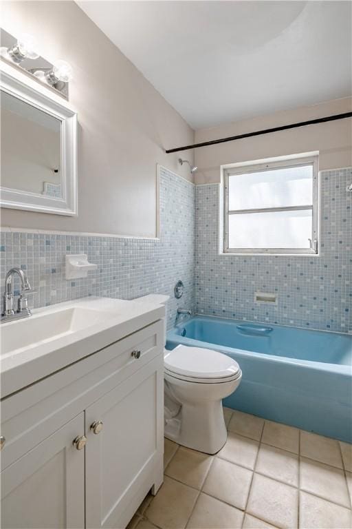 1936 5th Ave, Vero Beach, FL 32960 - full bath with tile patterned floors, shower / bathtub combination, vanity, tile walls, and a wainscoted wall