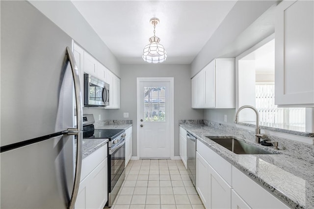1936 5th Ave, Vero Beach, FL 32960 - kitchen featuring stainless steel appliances, white cabinetry, and light stone countertops