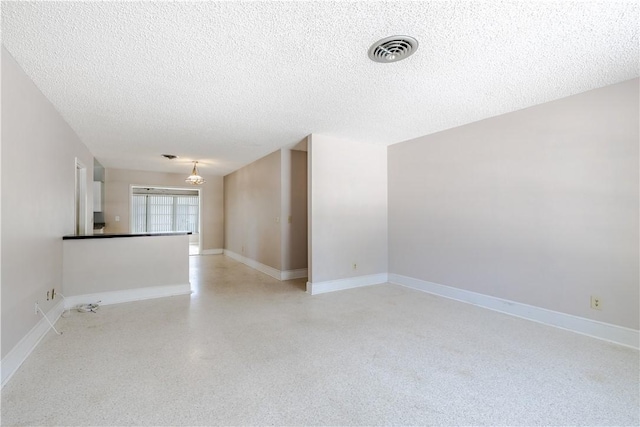 1936 5th Ave, Vero Beach, FL 32960 - spare room featuring a textured ceiling and a chandelier