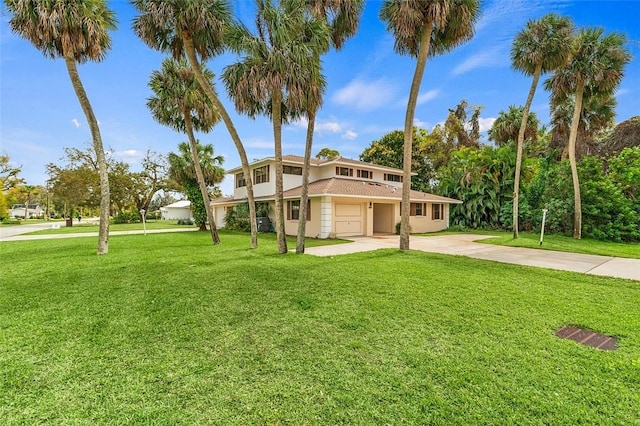 mediterranean / spanish home featuring a garage and a front lawn