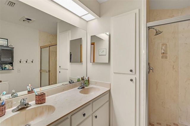 bathroom featuring vanity and a shower with shower door